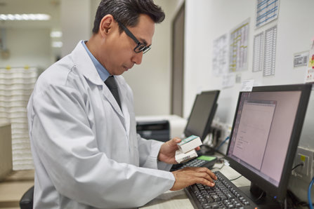 Doctor checking prescription in a computer
