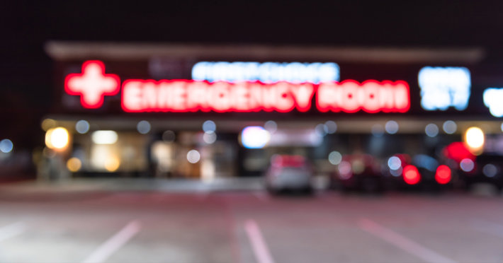 Blurred emergency room sign above entrance